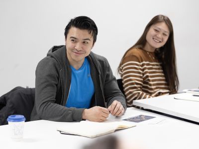 Participants sitting at desk smiling